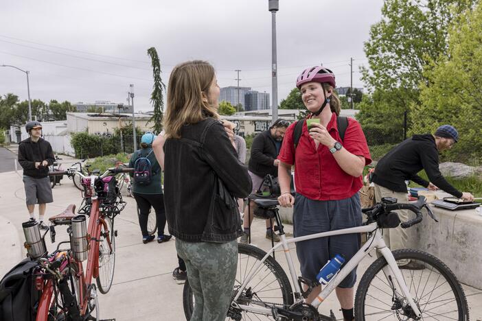 Bicycle commuters stop to grab a cup of coffee and a chat on their way into work as part of Portland's "Breakfast on the Bridges."
