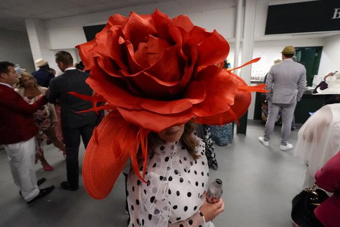 Brittany McKewn, of Asheville, N.C., wears a hat shaped like a rose before the 148th running of the Kentucky Derby horse race at Churchill Downs on May 7, 2022, in Louisville, Ky.