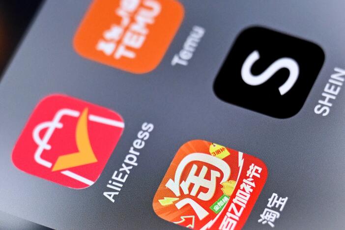 An illustration photo of the logos of Chinese shopping apps Taobao, AliExpress (left), Shein (right) and Temu on a smartphone screen.