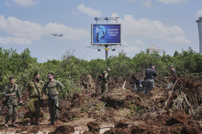 Israeli security forces inspect the site where the Israeli military said a projectile fired by Yemen's Houthi rebels landed in the area of Ben Gurion International Airport near Tel Aviv, Israel, on Sunday, May 4, 2025.
