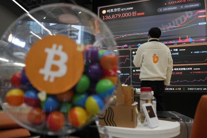 FILE - An employee watches an electronic signboard displaying the prices of Bitcoin and other cryptocurrencies at the lounge of Bithumb cryptocurrency exchange in Seoul, South Korea, Nov. 21, 2024.