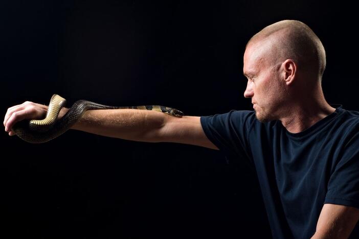 Tim Friede, pictured here with a water cobra, exposed himself to snake venom over decades. Scientists say they have now made a broadly effective antivenom with the help of his antibodies.