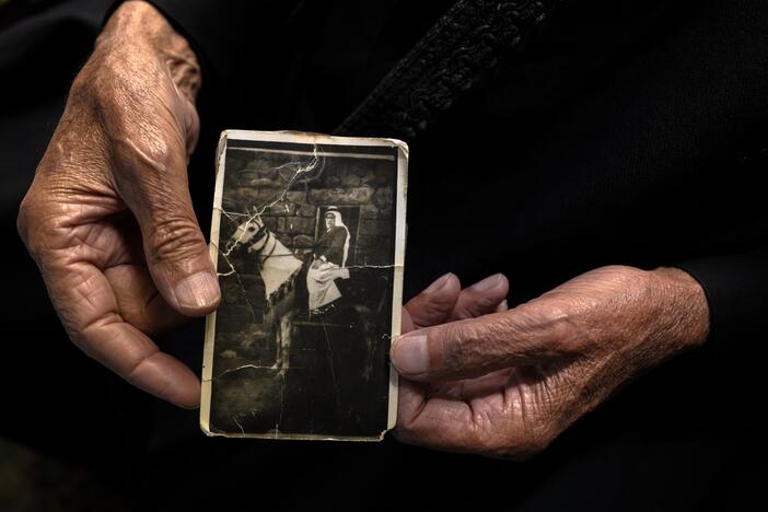 Nawaf Nasr, a 78-year-old member of Syria's Druze community, holds a creased black-and-white photo that he says shows him on horseback in a previous life before he died. The Druze religion holds that reincarnation is a path to spiritual purification.