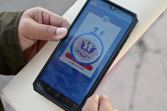 An asylum seeker with a canceled appointment to enter the United States waits to speak to a Mexican immigration official as he reviews the CBP One app at the El Chaparral border crossing port in Tijuana, Mexico, in January 2025.
