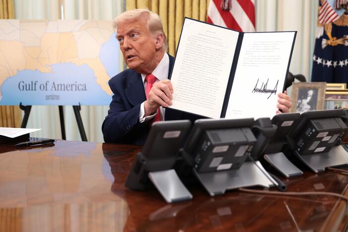 President Donald Trump signs executive orders in the Oval Office of the White House on March 6, including an order terminating the security clearances of those who work at the law firm Perkins Coie.