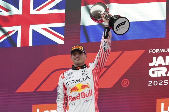 F1 driver Max Verstappen of the Netherlands raises his trophy after the Japanese Formula One Grand Prix on April 6, 2025.