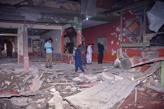 Local residents and members of the media examine a building damaged by a suspected Indian missile attack near Muzaffarabad, the capital of Pakistan-controlled Kashmir, on Wednesday.