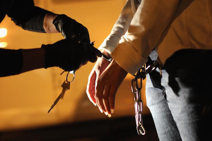 An Immigration and Customs Enforcement officer prepares a Salvadoran immigrant without legal status for a deportation flight.