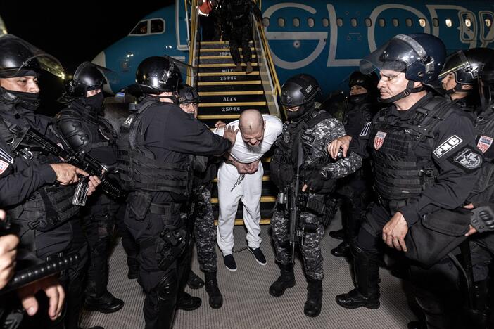 Salvadoran guards escort alleged members of the 'Tren De Aragua' and Mara Salvatrucha gangs who were deported from the U.S. to El Salvador.