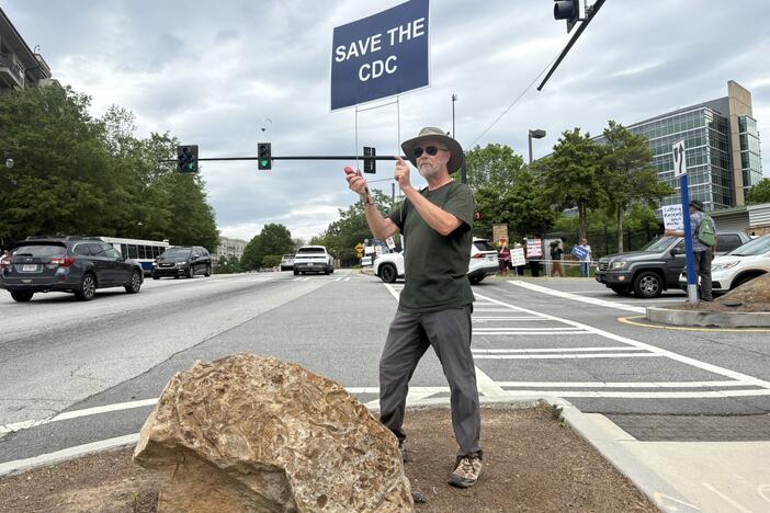 Michael Beach, former deputy director of the Division of Foodborne, Waterborne and Environmental Diseases at CDC, attends a weekly protest outside the agency's main campus in Atlanta.