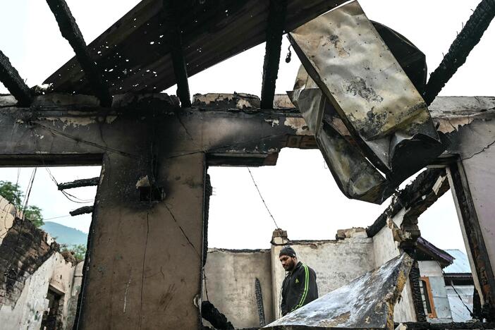 A man stands inside his house destroyed by Pakistani artillery shelling in the village of Salamabad, India, Thursday.
