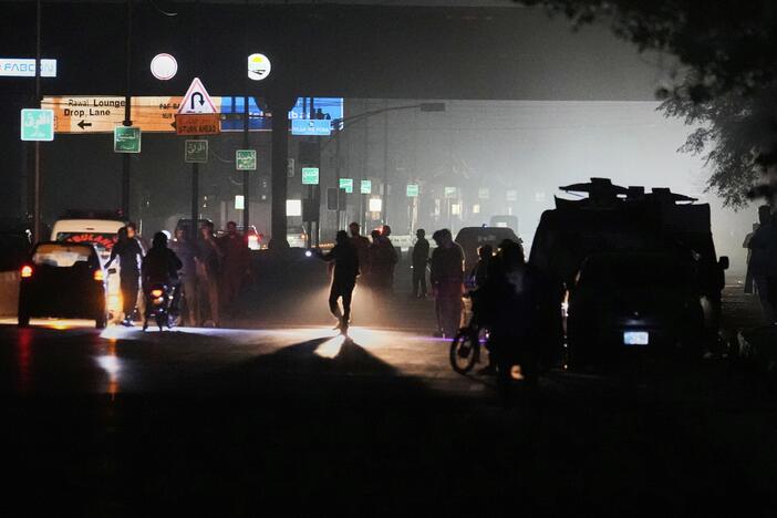 Pakistani police officers remove vehicles and people from the main entry of Nur Khan airbase following an Indian missile strike in Rawalpindi, Pakistan, on Saturday.