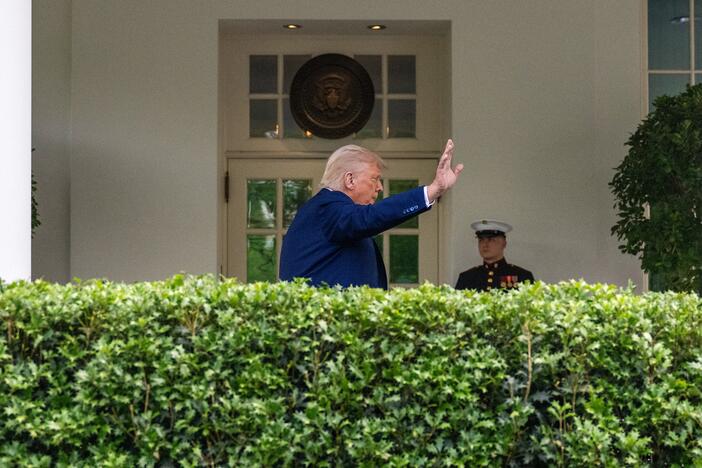 President Trump waves after taking questions from reporters outside the White House on May 8.