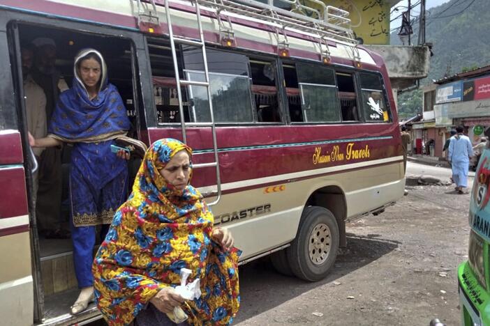 Local residents depart a passenger bus upon their arrival at a bus terminal, day after the ceasefire between Indian and Pakistan was announced, in Chakothi, near Line of Control, some 61 kilometres (38 miles) from Muzaffarabad, the capital of Pakistan controlled Kashmir, Sunday, May 11, 2025.