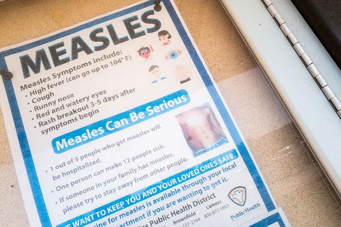 A measles advisory is shown tacked to a bulletin board outside Gaines County Courthouse on April 09, 2025 in Seminole, Texas.