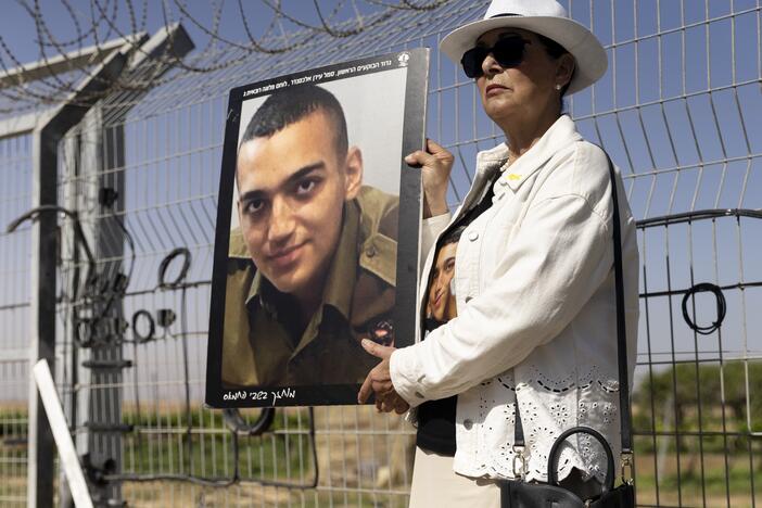 Varda Ben Baruch holds a photo of her grandson Israeli American hostage Edan Alexander during a rally of families of hostages held in the Gaza Strip on April 20 in Nir Oz, Israel.