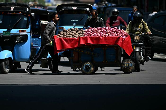 A vendor pushes his cart across a road in Srinagar on Monday. The frontier between India and Pakistan had the "first calm night in recent days," the Indian army said on May 12, after a weekend ceasefire.