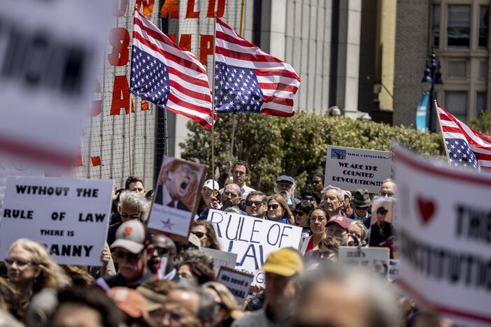 Attendees hold inverted U.S. flags, a sign of distress,  during a rally organized by the Bar Association of San Francisco in support of attorneys and law firms targeted by President Donald Trump on May 1.