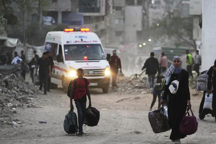 Palestinians evacuate after the Israeli army issued an evacuation warning for several schools and a hospital in Gaza City's Rimal neighborhood, Wednesday, May 14, 2025.