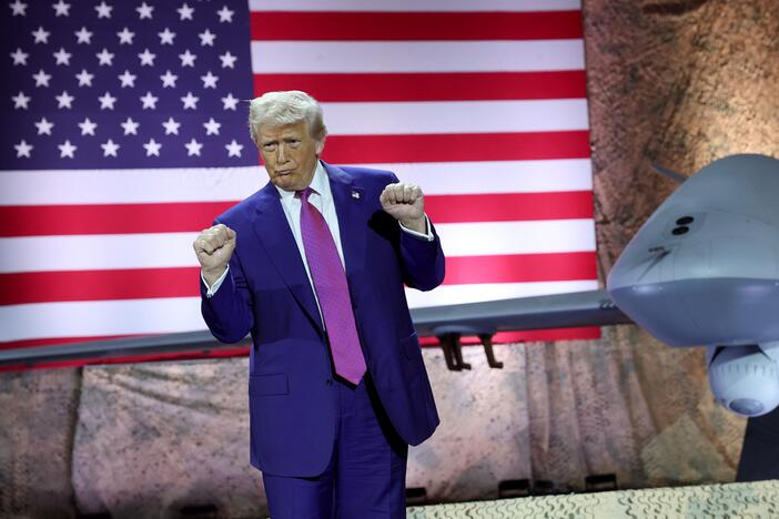 President Trump dances as his campaign song "God Bless the U.S.A." plays on stage at the Al Udeid Air Base in Qatar on May 15, 2025.