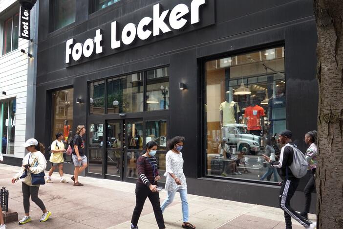 People walk by a Foot Locker store in Chicago.