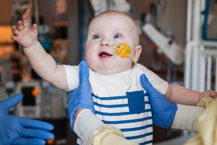 KJ Muldoon, who was born at Children's Hospital of Philadelphia in August, reaches out to doctors after being treated for a rare genetic disorder using CRISPR technology.