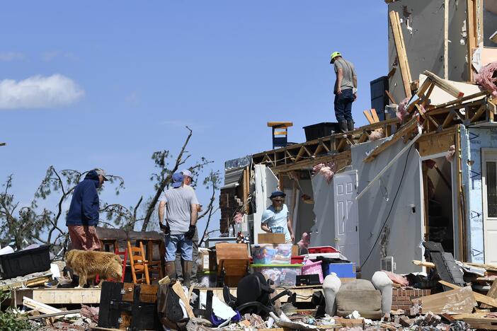 Family members cull through the debris of their home that was destroyed by a severe storm in London, Ky., on Saturday.