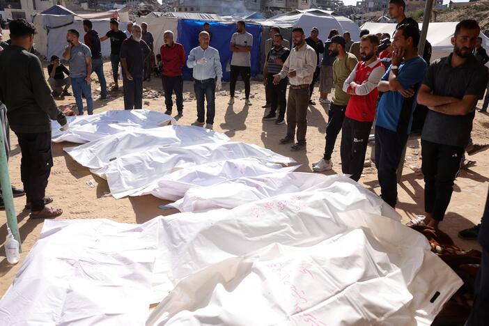 People surround the bodies of Palestinians killed in an Israeli strike in front of the Indonesian hospital in Beit Lahia in the northern Gaza Strip, on Friday.