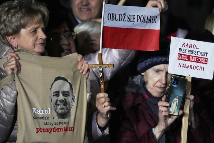 Supporters of conservative presidential candidate Karol Nawrocki hold up signs as they rally in Warsaw, Poland, Tuesday, May 13, 2025. The writing reads: Karol, the man who will become president, Wake up, Poland! and Our president Karol Nawrocki.