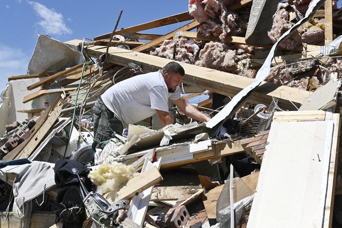 Anthony Broughton digs through the debris of his destroyed home following a severe storm in London, Ky., on Saturday.