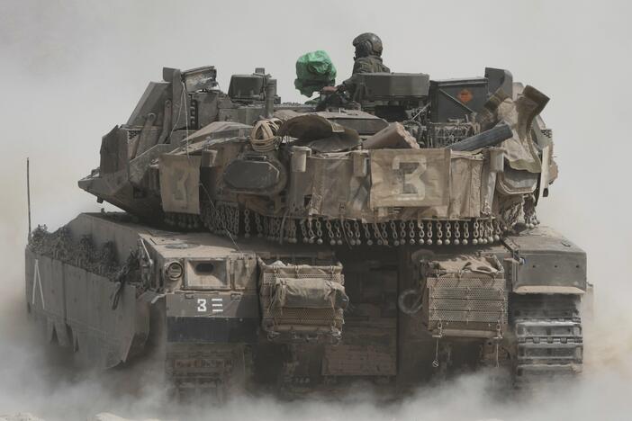 Israeli soldiers move tanks around staging area near the border with the Gaza Strip, in southern Israel, Sunday, May 18, 2025.