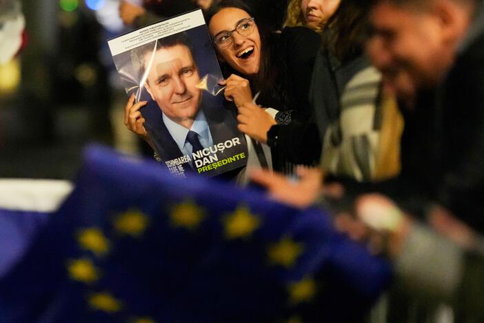 Supporters of presidential candidate Nicusor Dan celebrate on the street after polls closed for the second round of the country's presidential election redo in Bucharest, Romania on Sunday.