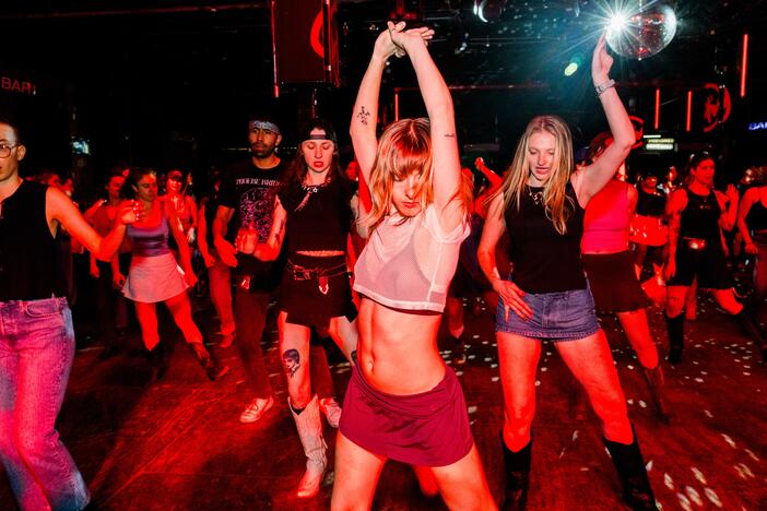 Kitty Horblit (left), Karli Manship (center) and Hannah Bruns (right) line dance at a Stud Country event on March 25, 2025, in Brooklyn, New York.