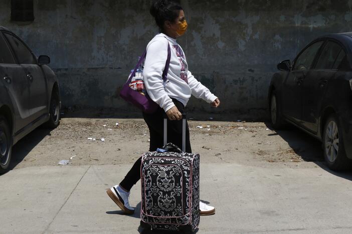 A Honduran migrant who returned voluntarily from the United States walks after arriving at Ramon Villeda Morales Airport in San Pedro Sula, Honduras on Monday.