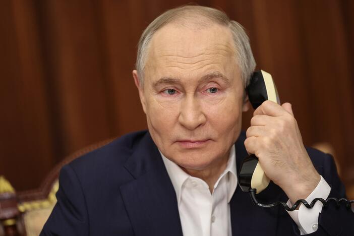 In this pool photograph distributed by Russian state agency Sputnik, Russia's President Vladimir Putin talks on the phone with 9th-grader Arina Porkhal from Gorlovka, Donetsk region, a participant in the charity event "Yolka Zhelaniy" ('Christmas Tree Wish'), fulfilling children's Christmas wishes, in Moscow on Jan. 7, 2025.