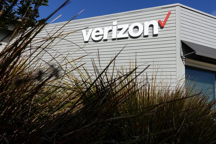 The Verizon logo is displayed on the exterior of a Verizon store. The FCC approved its $20 billion deal to buy Frontier Communications, a day after Verizon told the U.S. regulator that it would end many of its diversity-related policies.