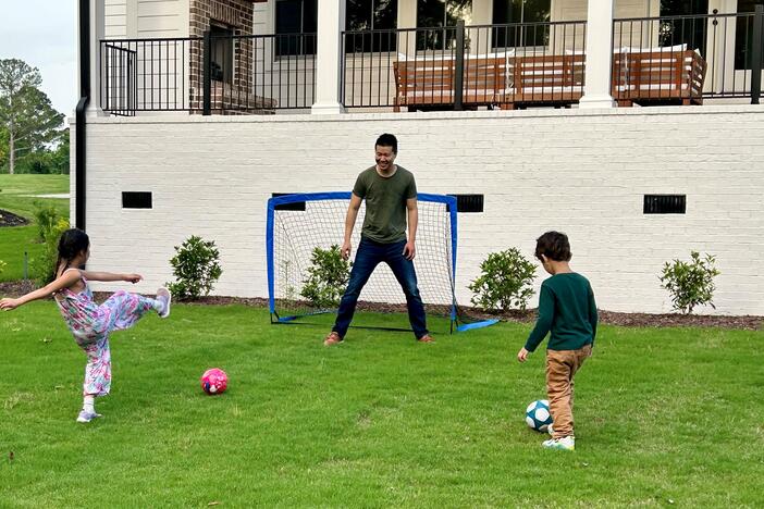 Jim Xiao paid an agent a flat $10,000 fee to help him buy a home in Evans, Ga., last year. Here, Xiao and his children play soccer at their new home.
