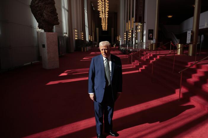 President Donald Trump talks to the media in the Hall of Nations during a tour at the John F. Kennedy Center for the Performing Arts after leading a board meeting on March 17, 2025.