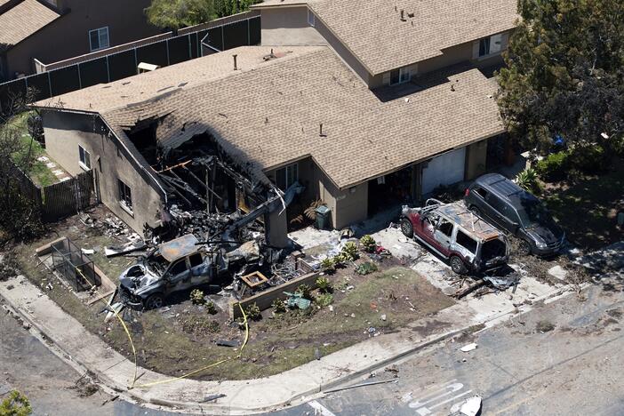 Debris covers the ground after a small plane crashed into a San Diego neighborhood, setting homes and cars on fire and forcing evacuations early Thursday, May 22, 2025.