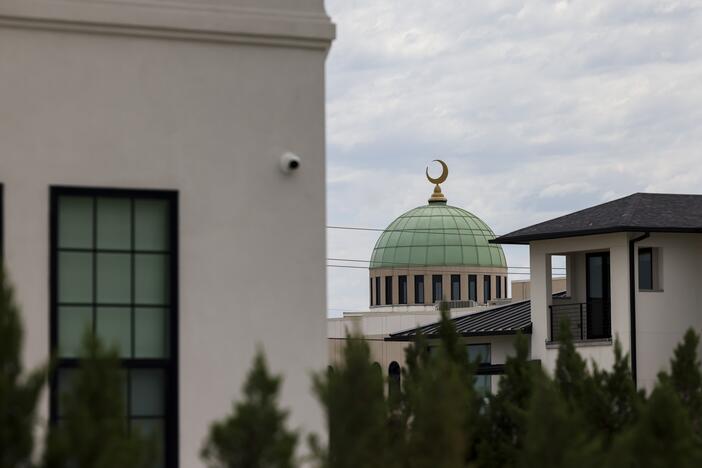 The Plano EPIC mosque is seen behind a row of homes in Plano. Many muslims like to live near their mosque to facilitate practicing their faith daily.