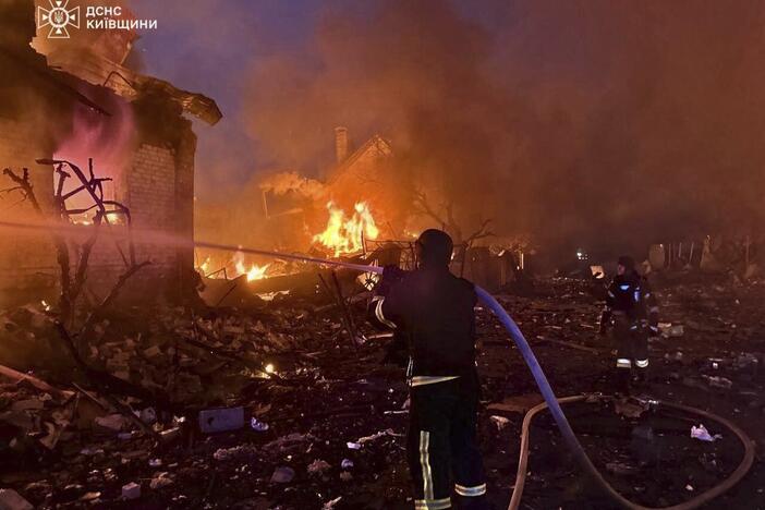 In this photo provided by the Ukrainian Emergency Service, firefighters try to put out a fire following a Russian attack in Kyiv region, Ukraine, Sunday, May 25, 2025.