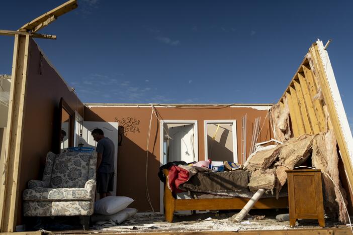 A person walks through a house in the community of Sunshine Hills outside of London, Kentucky. A tornado struck the neighborhood just after midnight on May 17.