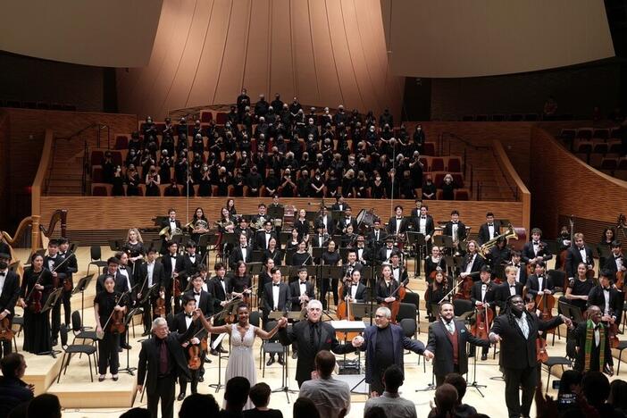 From left: Tenor Alexander Taite, baritone Wilford Kelly, mezzo-soprano Samantha Rose Williams, conductor Paul Phillips, composer Adolphus Hailstork and librettist Herbert Martin appear at a 2023 performance with the Stanford Symphony Orchestra and Stanford Symphonic Chorus of <em>A Knee on the Neck</em>, a requiem cantata in honor of George Floyd. The performance marked the West Coast premiere of the piece.