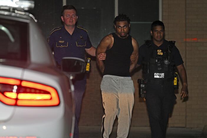 Troopers with Louisiana State Police escort Orleans Parish Prison escapee Lenton Vanburen to a waiting vehicle late Monday, May 26, 2025, at Louisiana State Police Headquarters after he was captured in Baton Rouge, La.