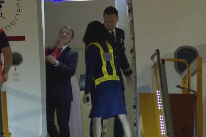 In a grab taken from video, France's President Emmanuel Macron is shoved while preparing to disembark a plane in Hanoi, Vietnam on Sunday.