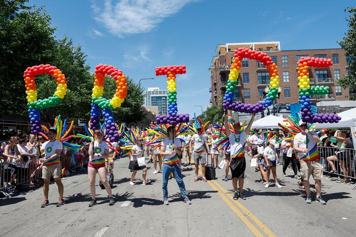 Participants carry balloons spelling out "Pride" during the 51st LGBTQ Pride Parade in Chicago on June 26, 2022.