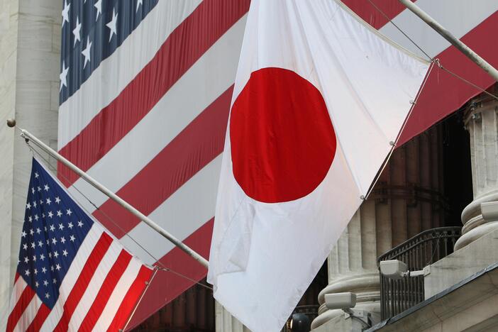 The flag of Japan (right) hangs outside the New York Stock Exchange on May 5, 2008, in honor of Ryozo Kato, the ambassador of Japan to the United States at the time, ringing the opening bell.