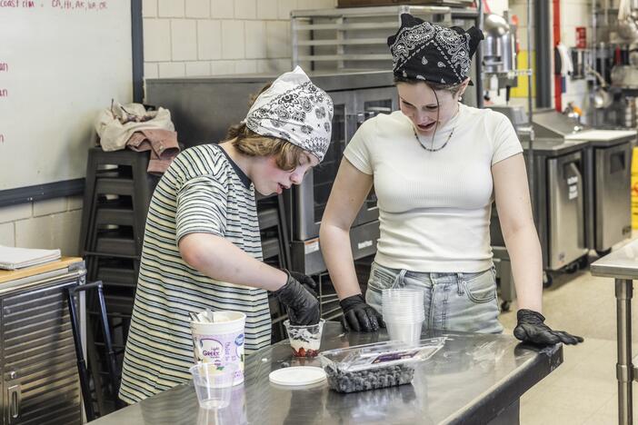 Sixth graders Connor Atkinson and Genevieve Plante work together to make yogurt parfaits in the after-school cooking club in their rural Maine school district.