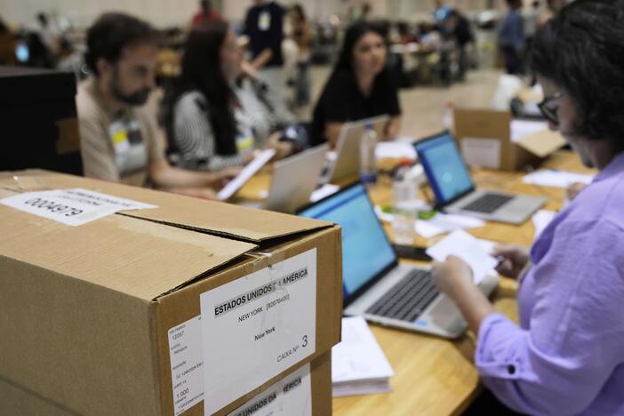 Boxes which arrived from New York and Boston containing votes for Portugal's May 18 general election are stacked on a desk where volunteers are registering them on the final day of counting of ballots from voters who live abroad, in Lisbon on Wednesday.