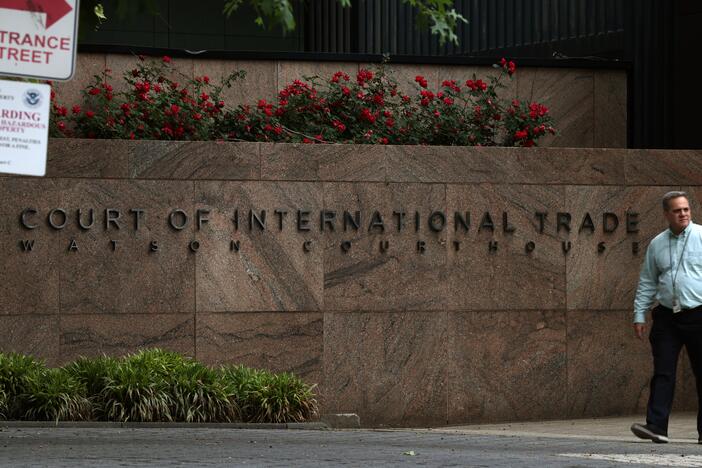 People walk past the U.S. Court of International Trade, Watson Courthouse, in lower Manhattan on Thursday. In a ruling that surprised many, the trade court ruled Wednesday in an opinion by a three-judge panel that a 1977 law called the International Emergency Economic Powers Act does not grant Trump "unbounded" authority to impose the worldwide and retaliatory tariffs he has issued by executive order. Then, on Thursday, the U.S. Court of Appeals for the Federal Circuit granted the Trump administration's re…